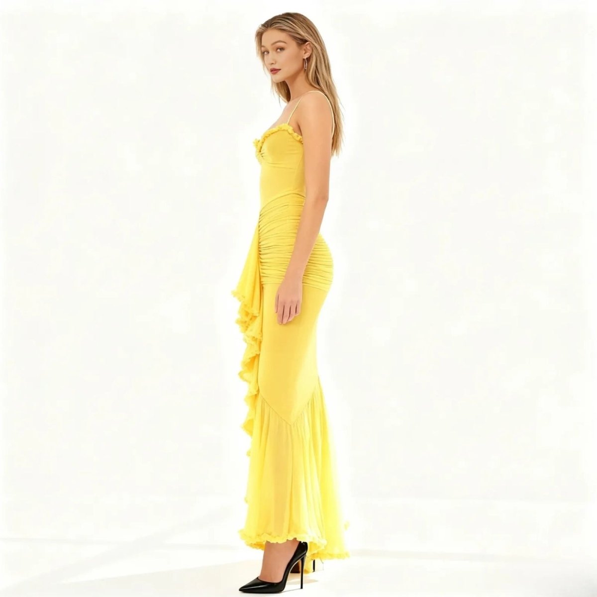 Woman wearing a yellow kouvr strapless dress with ruched details on a white background