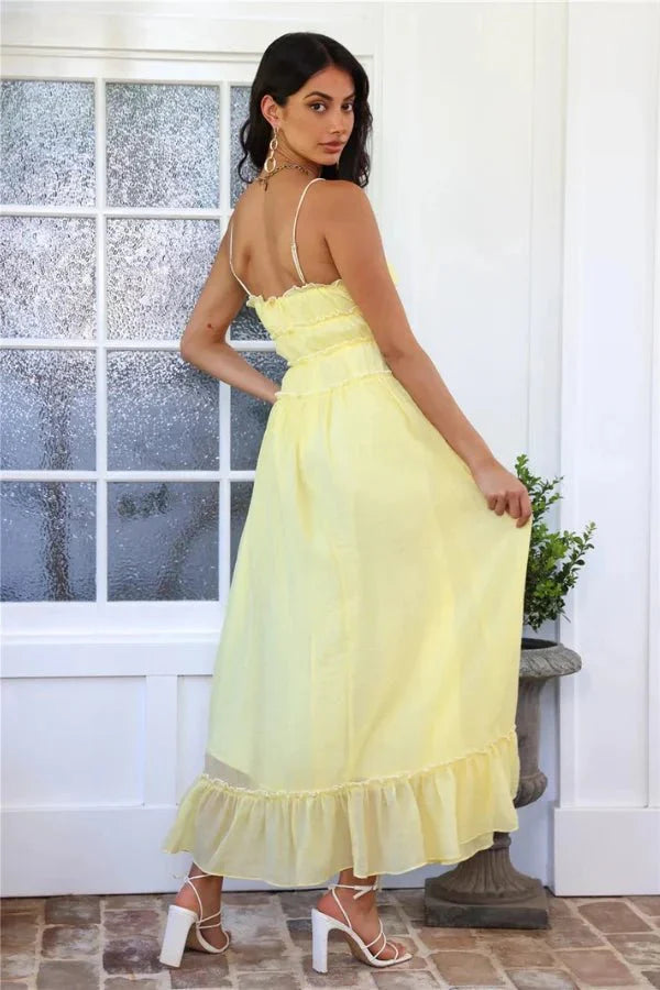 Model wearing the Kouvr Fashion Yoona Yellow Ruffle Midi Dress in a sunlit room