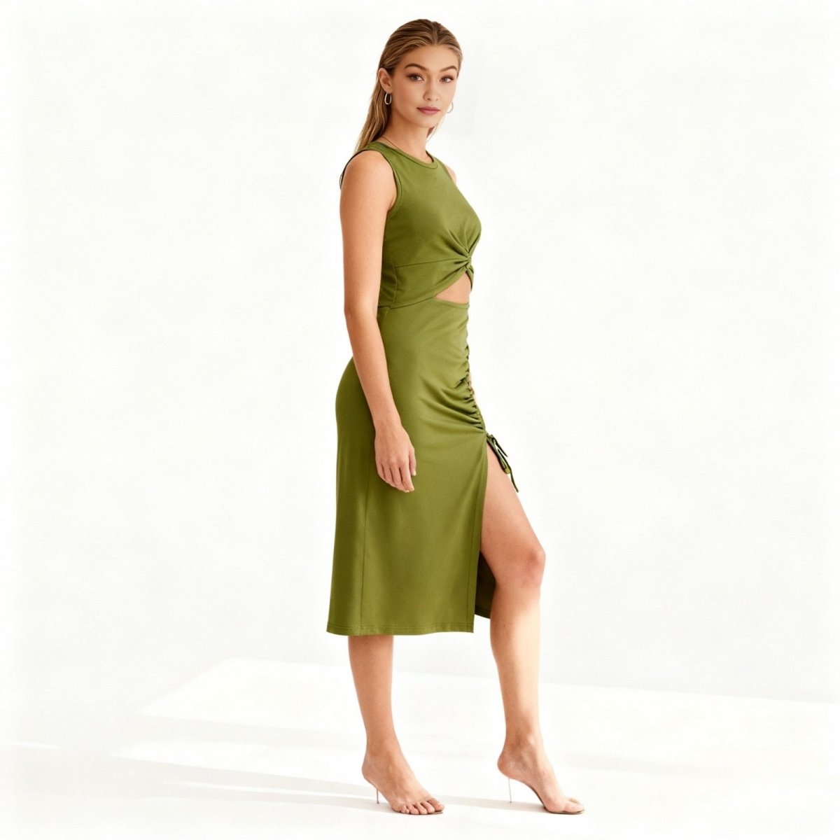 Woman wearing a green Kouvr dress with a cutout design on a white background