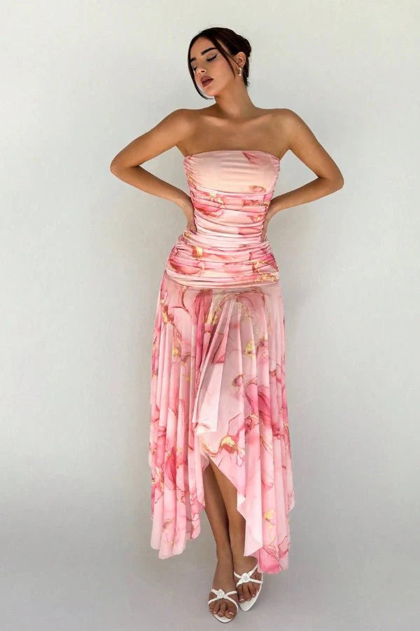 Model wearing the Kouvr Floretta pink floral ruched strapless dress with an asymmetrical chiffon skirt
