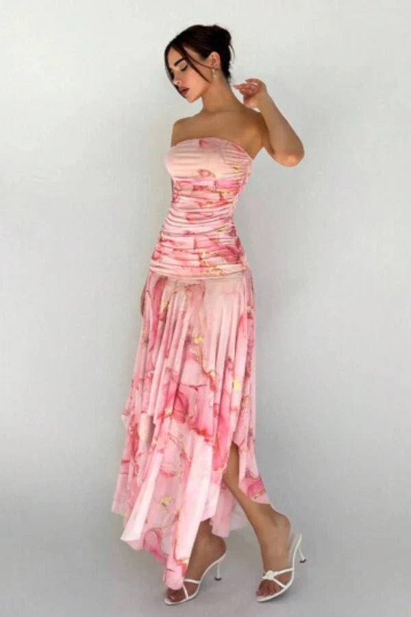 Model wearing the Kouvr Floretta pink floral ruched strapless dress with an asymmetrical chiffon skirt