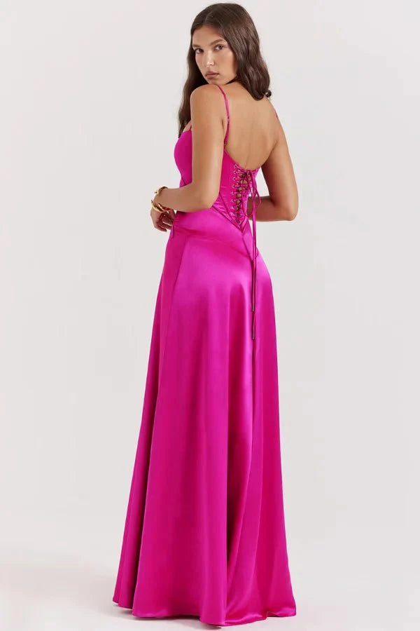 Model wearing the Kouvr Gabriella Gown in Fuchsia Satin with a lace-up corset back.
