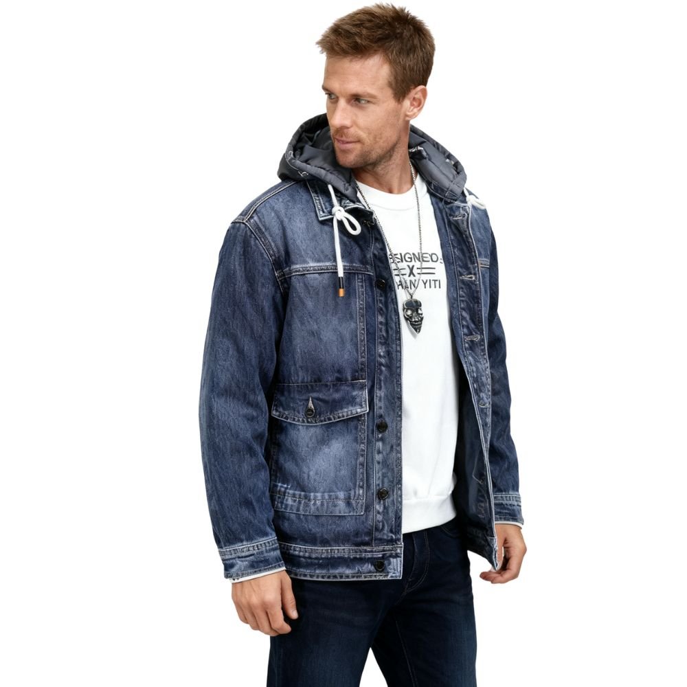 Man wearing a blue kouvr denim jacket with a hood on a white background