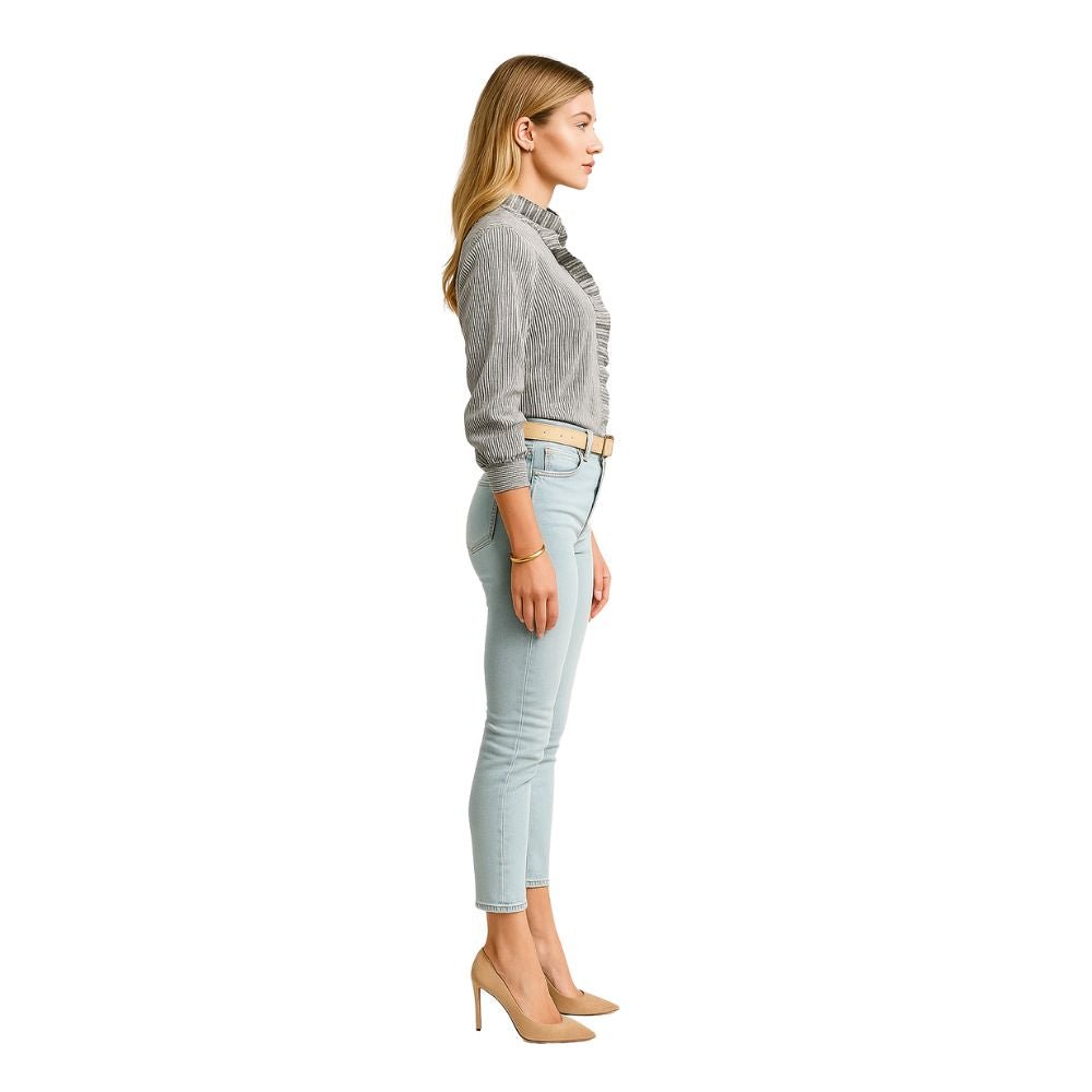 Model wearing the Kouvr Fashion Ruffle Neck Blouse, tucked into high-waisted light-wash jeans