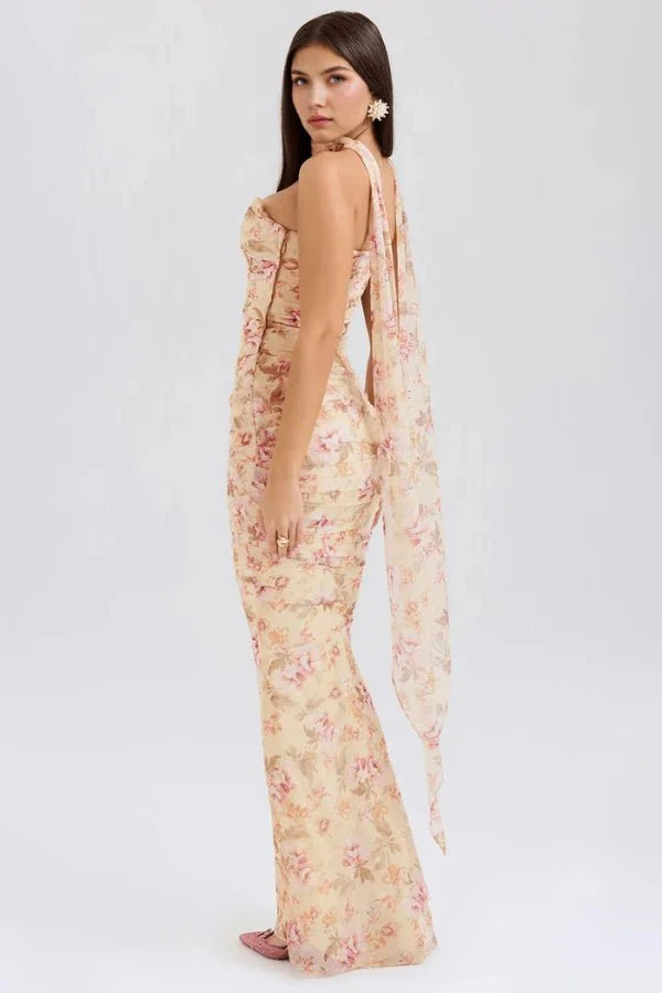 Model showing back angle of Kouvr Hailey floral strapless maxi dress, highlighting the flowing scarf detail.
