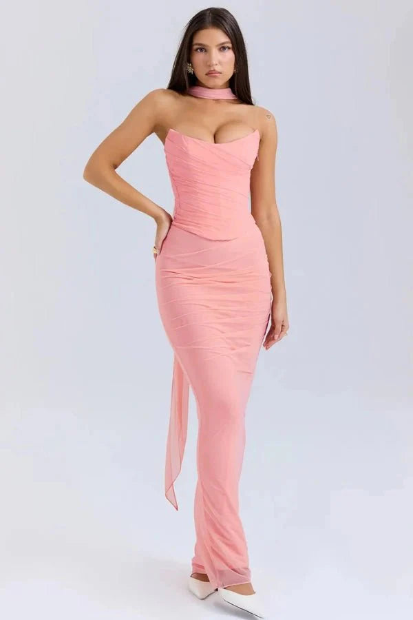 Model wearing the Hailey pink ruched mesh maxi dress with matching detachable choker by Kouvr, front view.