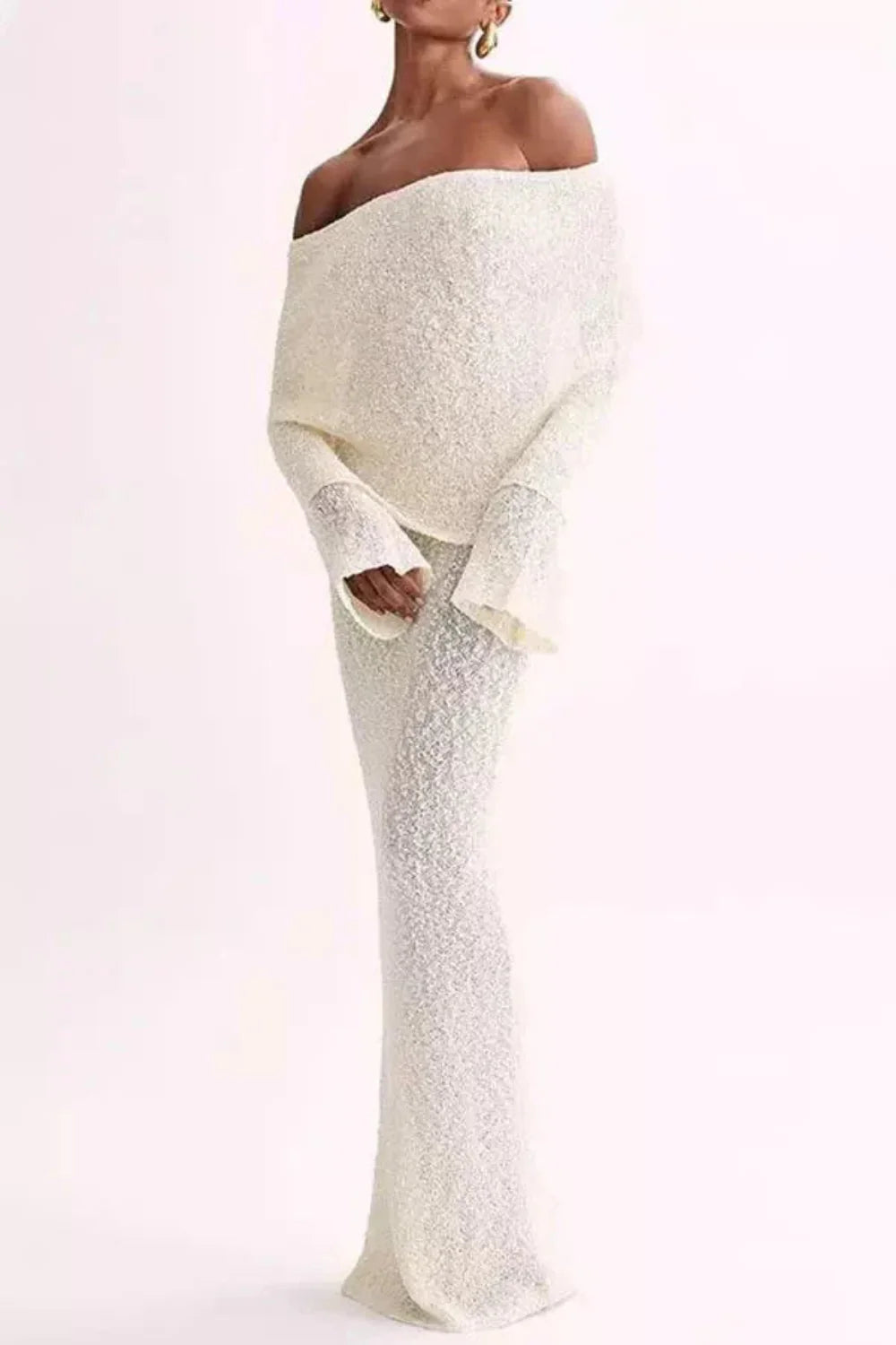 Model wearing Kouvr's ivory off-the-shoulder knit maxi gown, front view