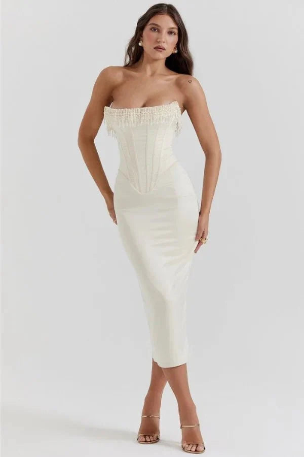 Model wearing Kouvr ivory satin strapless corset dress with pearl fringe
