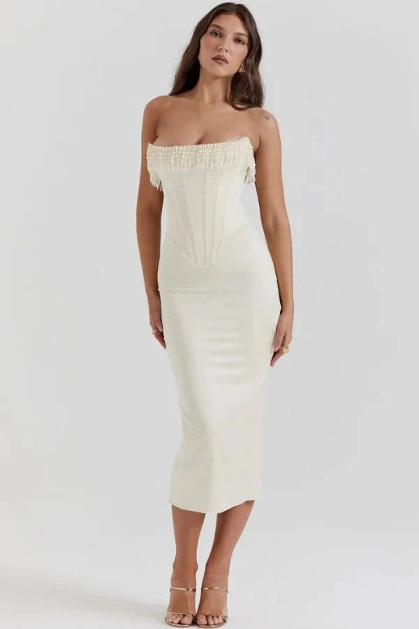 Model wearing Kouvr ivory satin strapless corset dress with pearl fringe