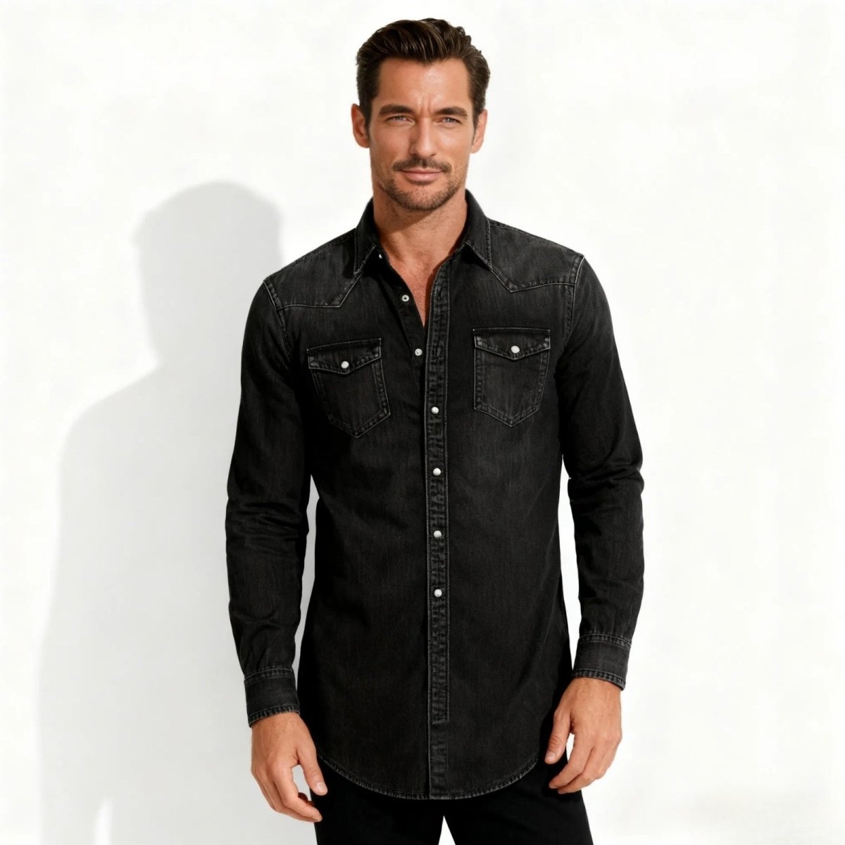 Man wearing a black Kouvr denim shirt on a white background