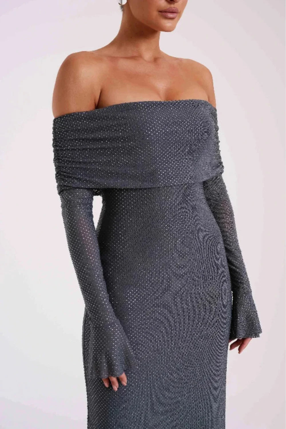 Model wearing Kouvr Jada long sleeve off-the-shoulder evening gown in gray