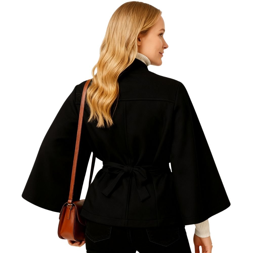 Model wearing the black Kouvr Jaye Cape Jacket, showcasing the tie-back belt and wide kimono sleeves