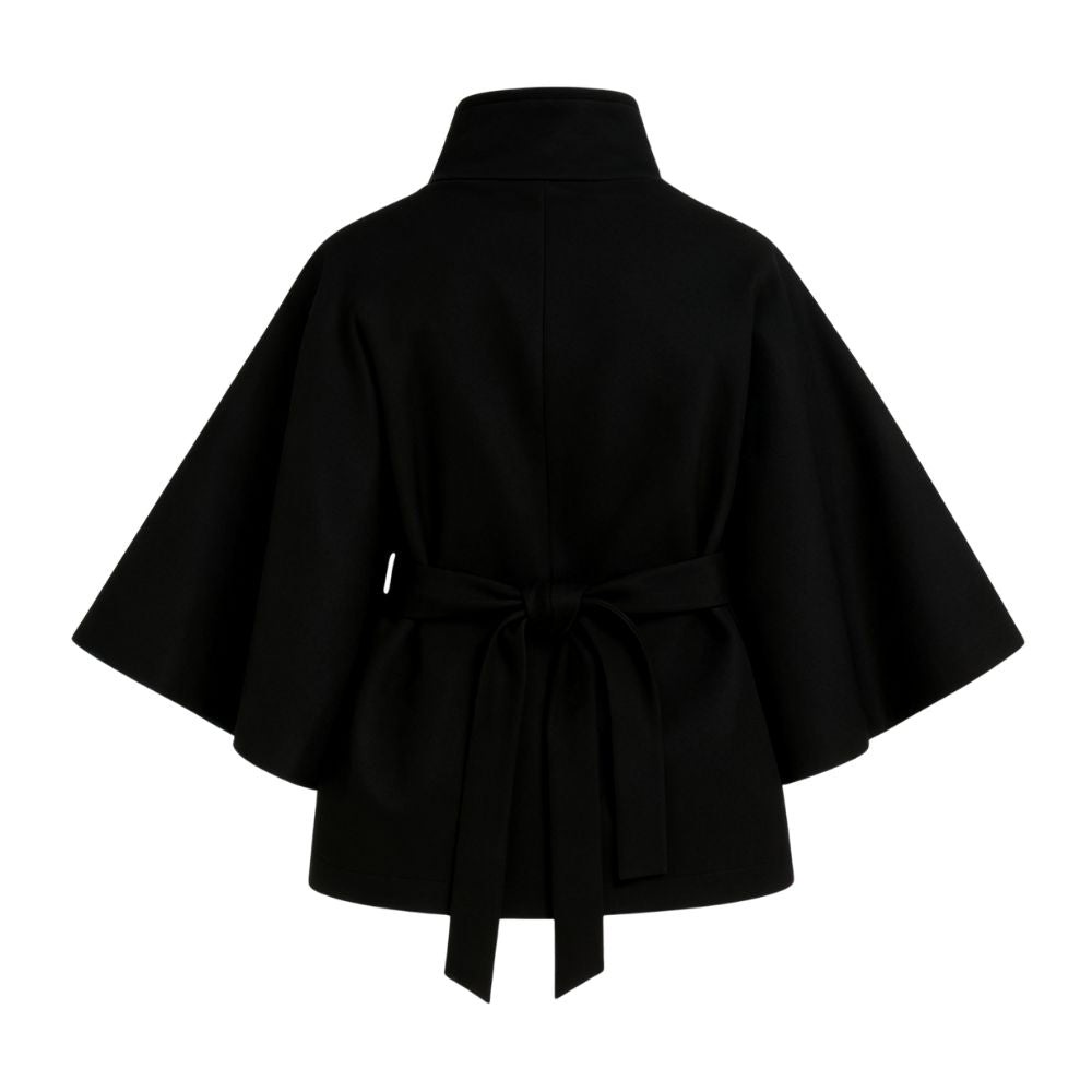 Model wearing the black Kouvr Jaye Cape Jacket, showcasing the tie-back belt and wide kimono sleeves