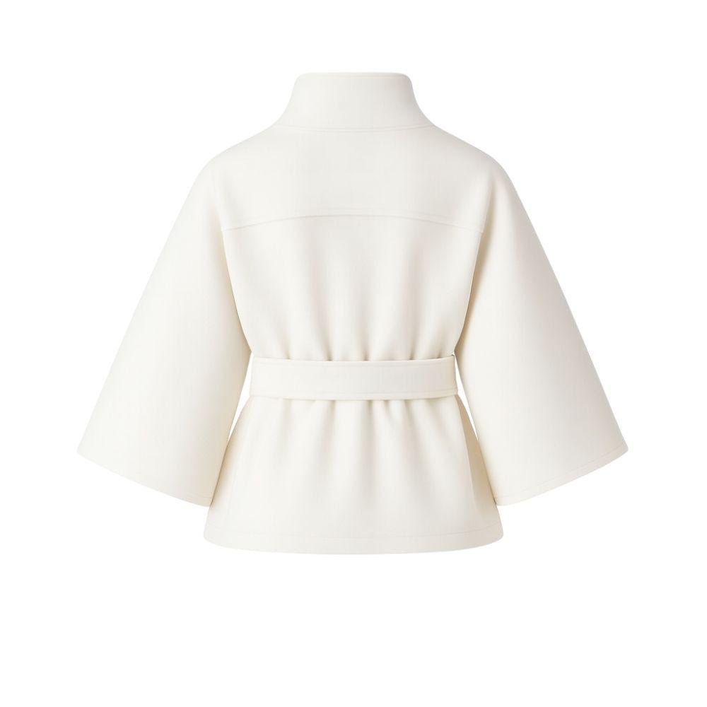 Model wearing Kouvr Fashion belted cape jacket with funnel neck and wide kimono sleeves