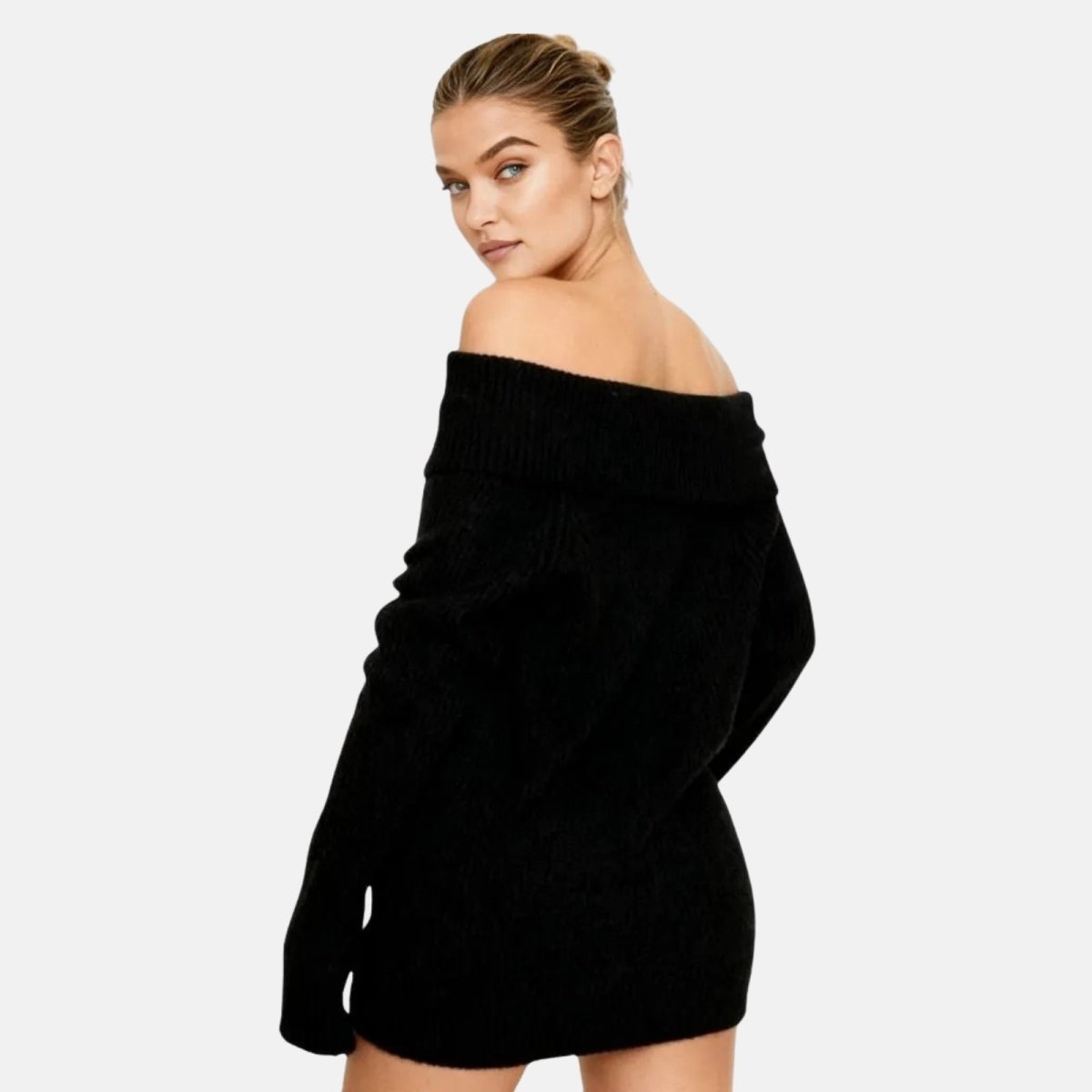 Woman wearing a black off-shoulder sweater dress on a white background