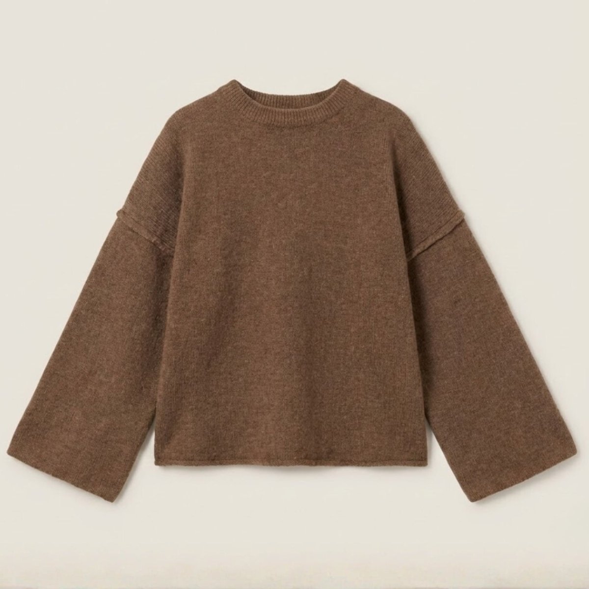 Flatlay product shot of the Kouvr Krystal bell sleeve sweater in brown, displaying the texture of the alpaca wool blend knit.
