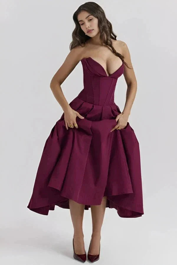 Model wearing Kouvr Fashion's burgundy strapless corset midi dress for a formal event