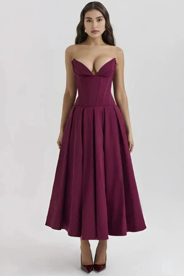 Model wearing Kouvr Fashion's burgundy strapless corset midi dress for a formal event