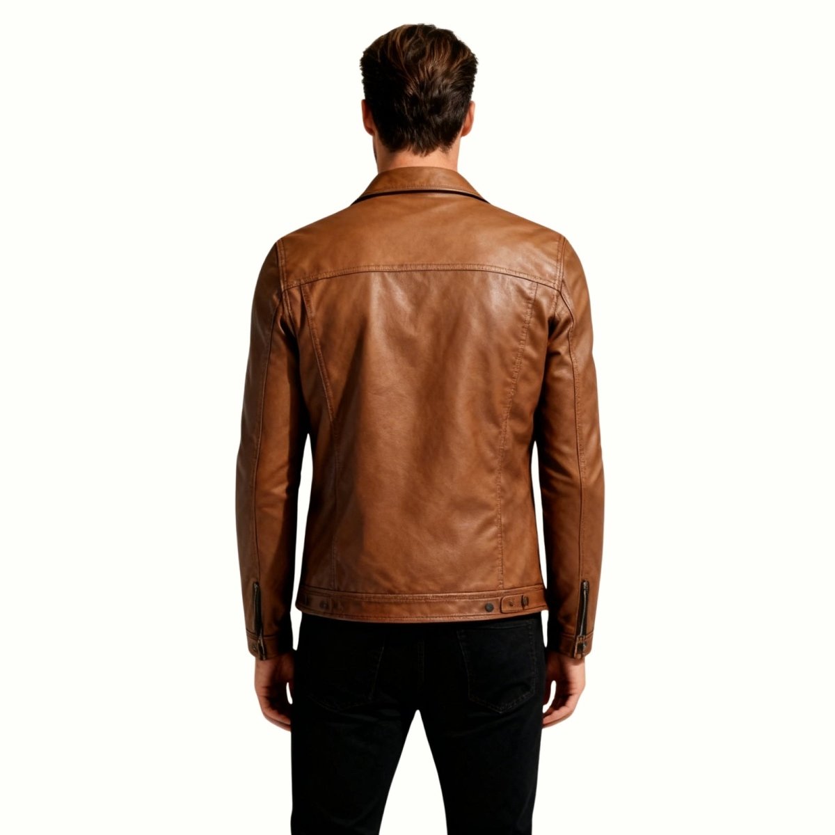 Back view of a male model in the Kouvr brown leather trucker jacket, displaying the back yoke and adjustable waistband tabs.