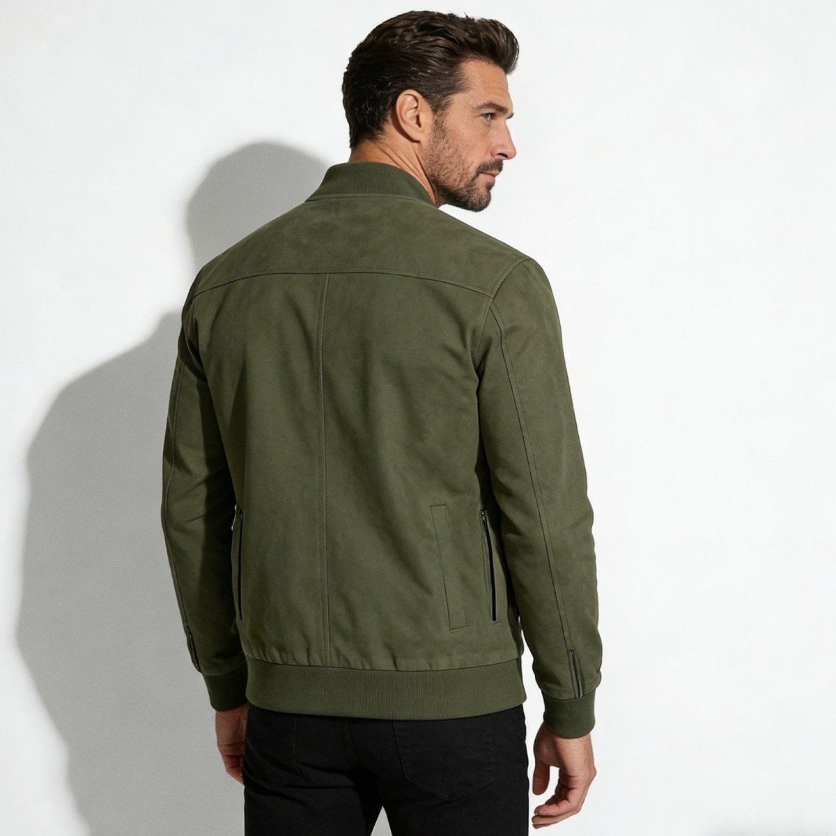 Back view of the Kouvr men's military green suede bomber jacket highlighting the shoulder yoke detail.