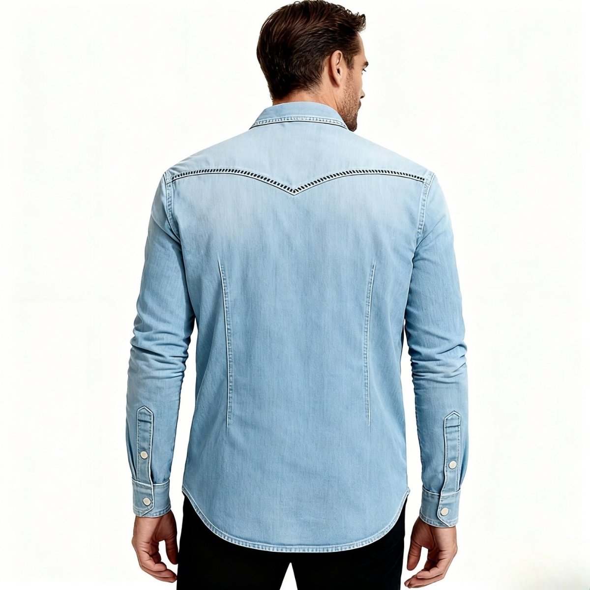 Man wearing a light blue Kouvr denim shirt on a white background