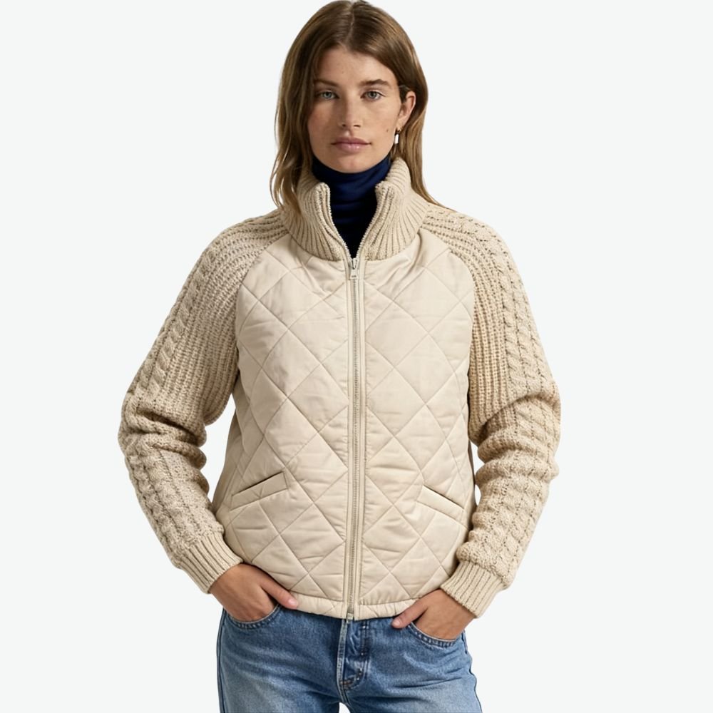 Woman wearing the Kouvr Mika khaki quilted jacket with cable knit sleeves, styled with jean