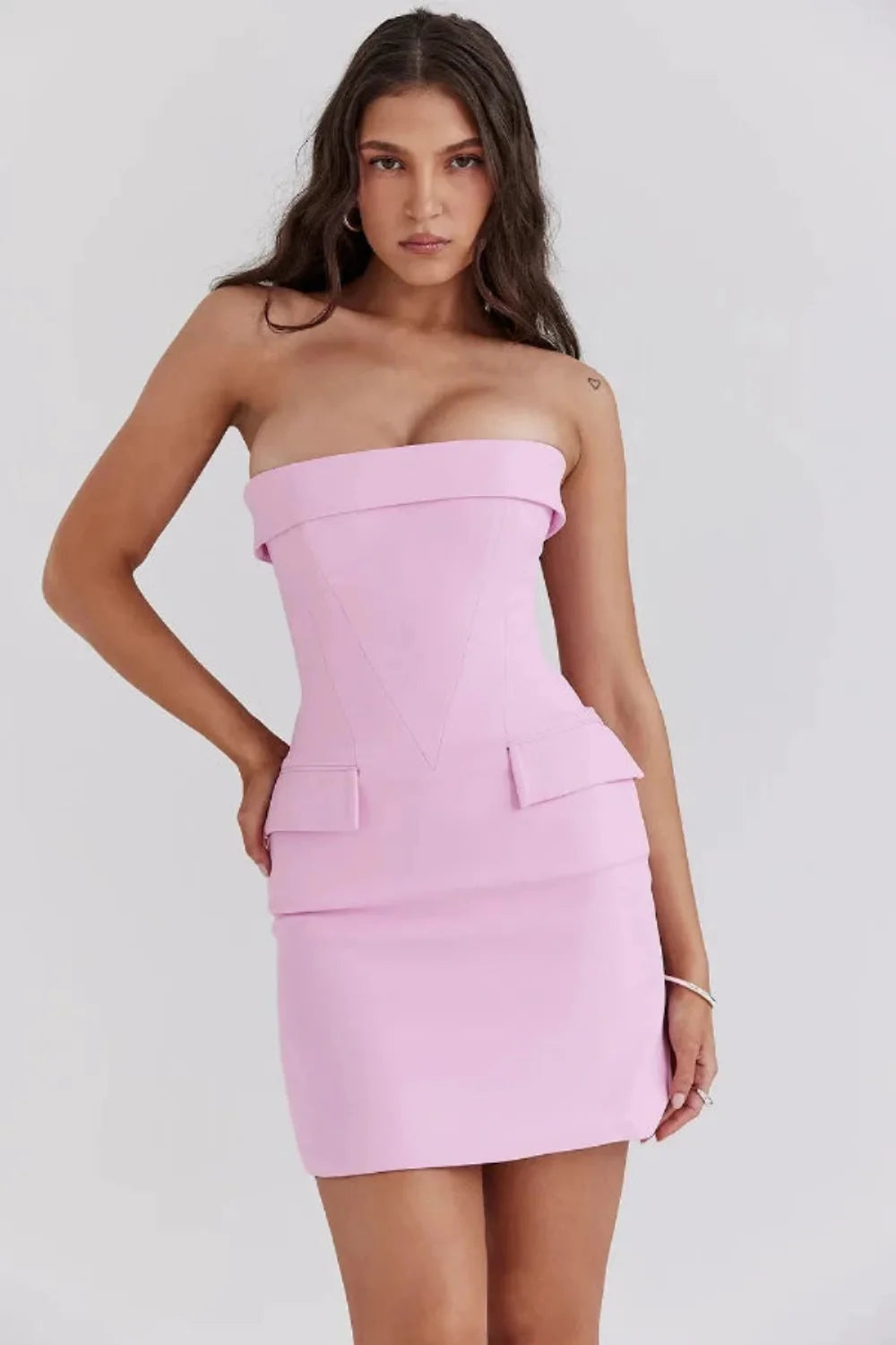 Model wearing the Kouvr strapless pink corset mini dress at an event
