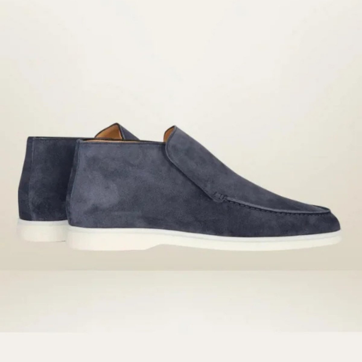 A pair of Kouvr Ralph men's navy suede slip-on shoes with a white sole, shown against a clean, light-colored studio background.