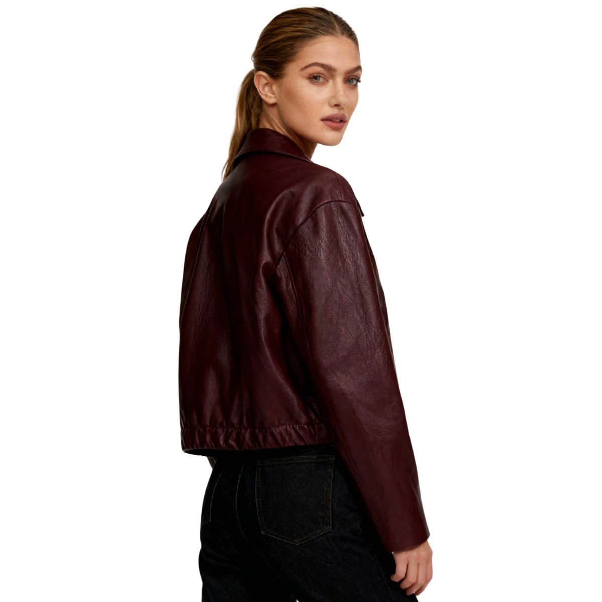 Woman wearing a burgundy Kouvr leather jacket on a white background