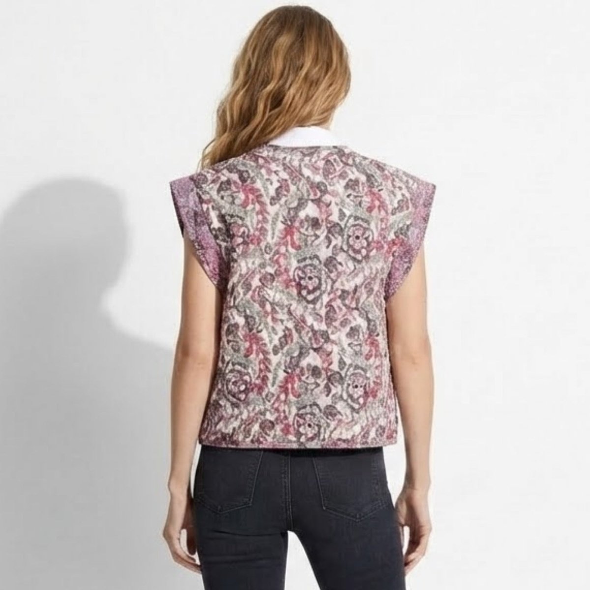 Back of the Kouvr Fashion Rose vest on a model, highlighting the detailed floral and paisley print and tailored fit across the shoulders.