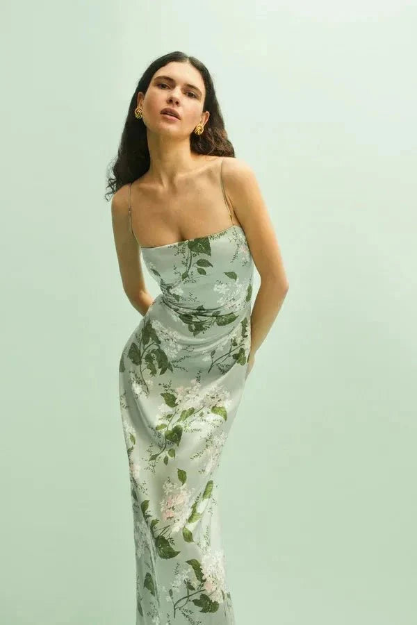 Model wearing the Kouvr Fashion Sage Green Silk Maxi Dress at an outdoor event
