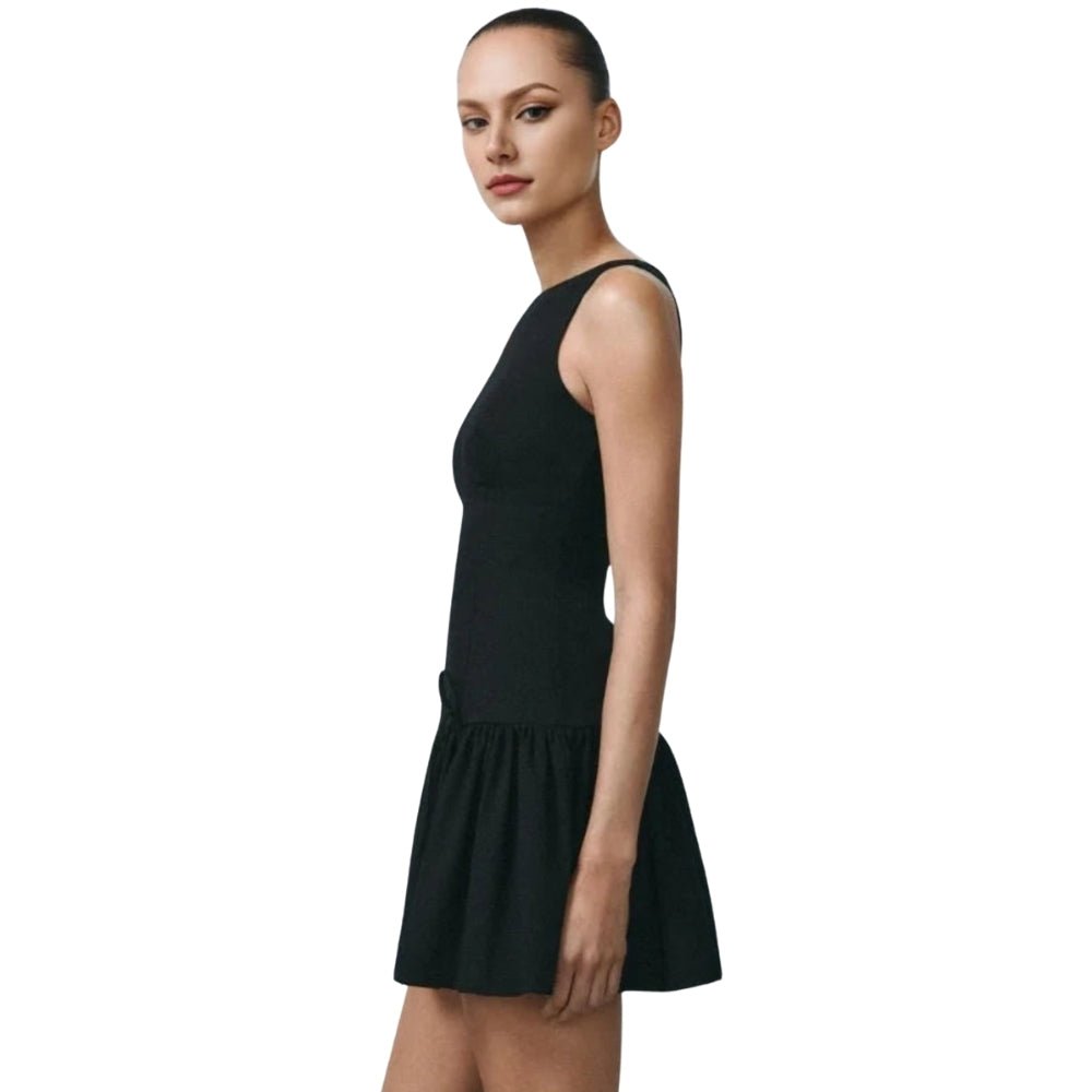Black Kouvr sleeveless dress worn by a model on a white background
