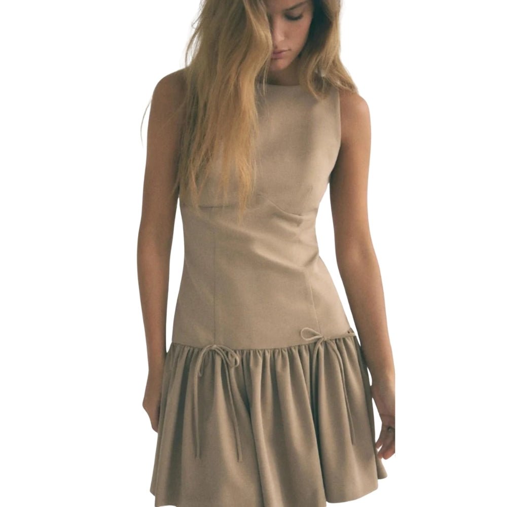Woman wearing a khaki Kouvr dress on a white background