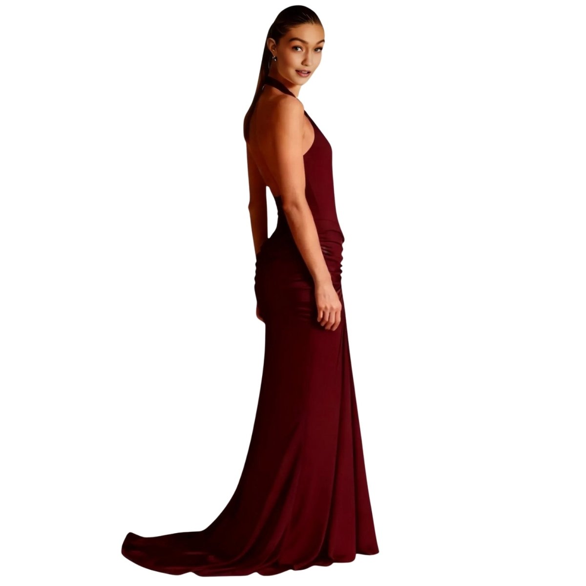 Woman wearing a burgundy Kouvr evening gown on a white background