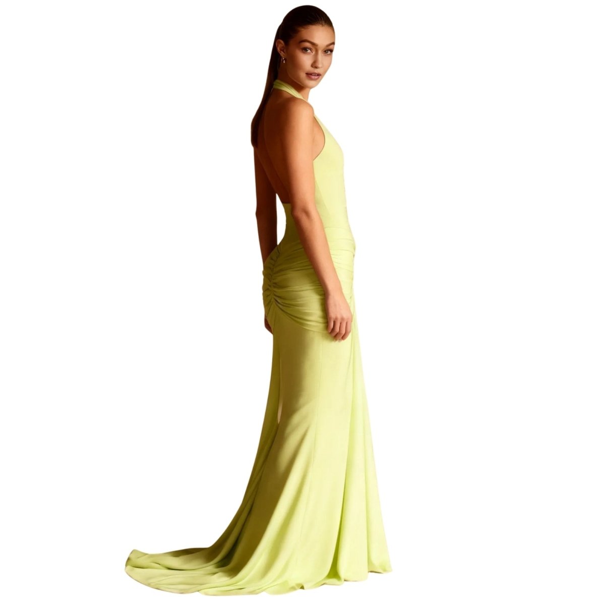 Woman wearing a light green Kouvr evening gown on a white background
