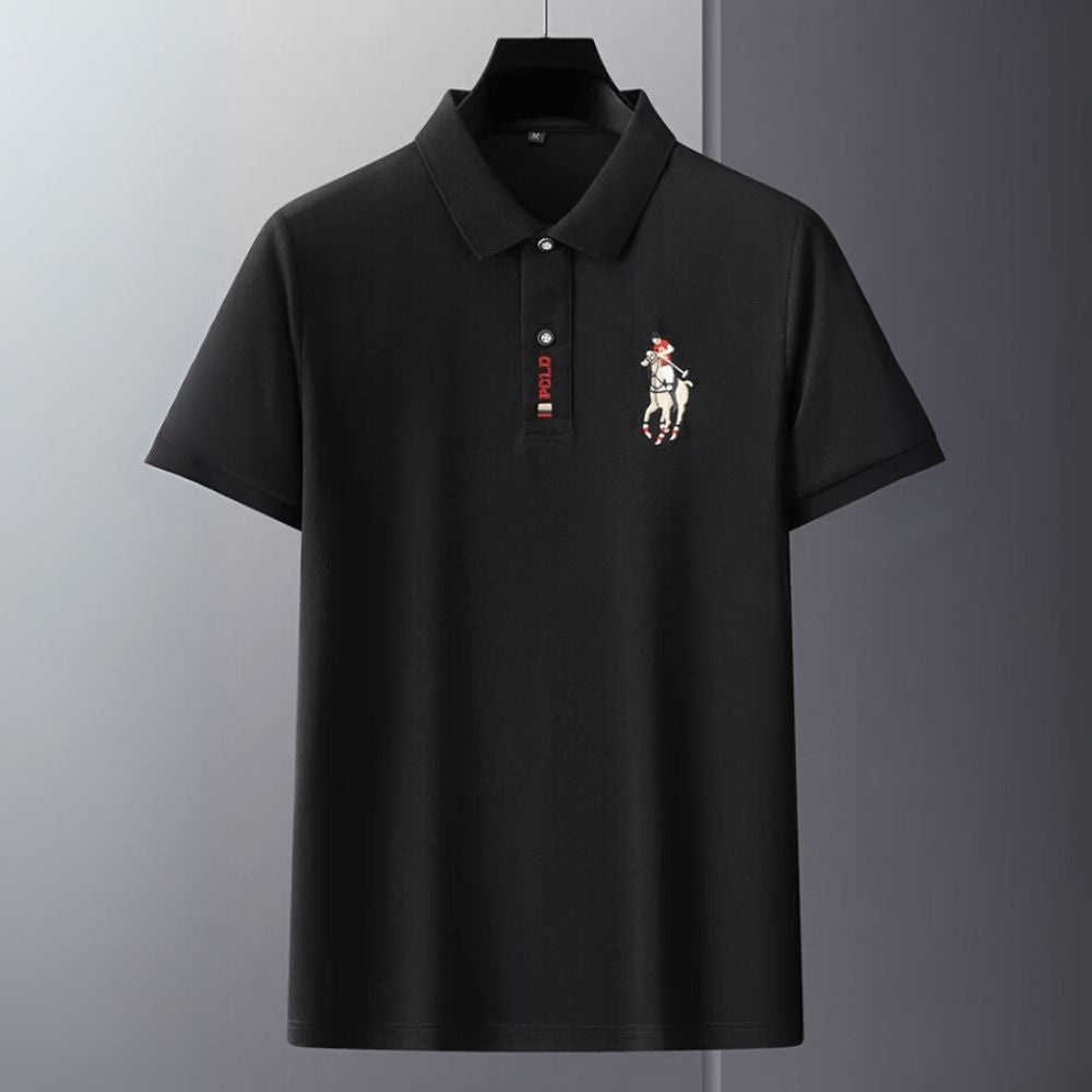 Man wearing the Kouvr Signature Black Polo Shirt with black trousers