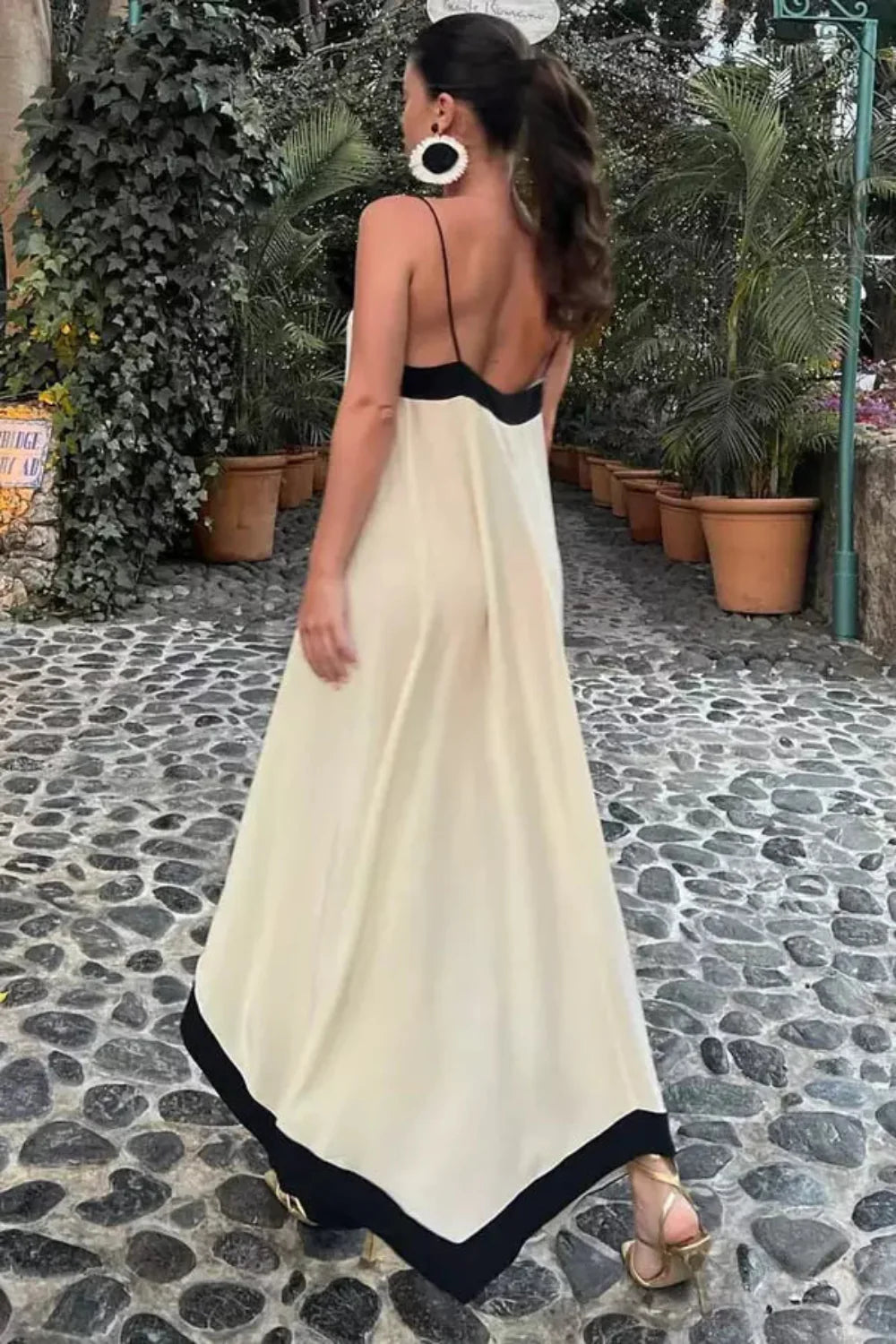 Model wearing The Dione silk maxi slip dress in white with a v-neck and low back