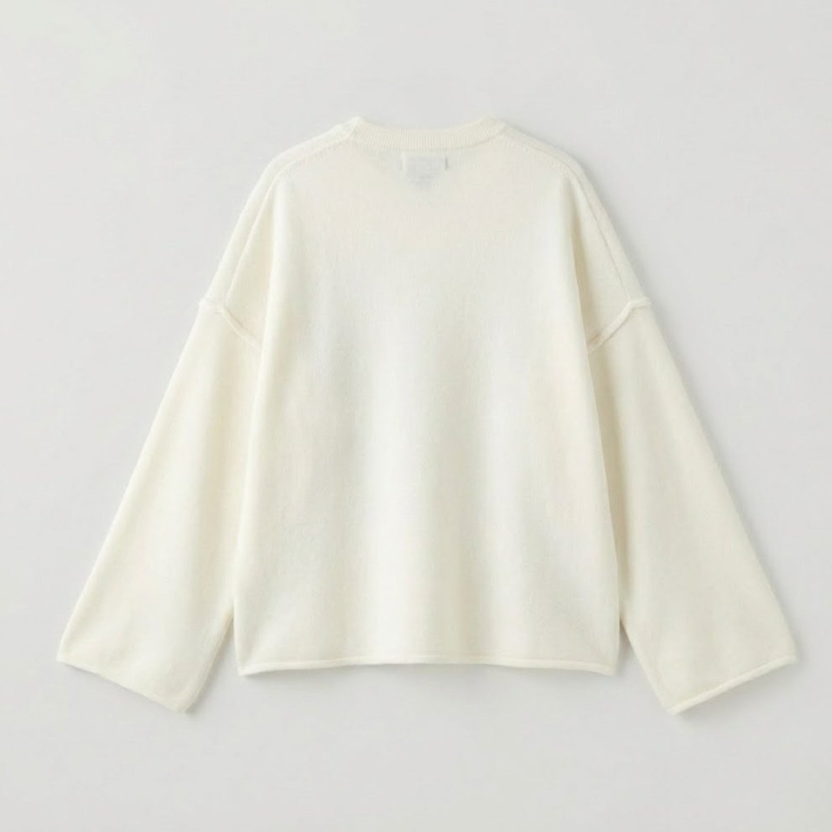 Back flat lay of the off-white Kouvr Architect sweater, detailing the simple, elegant construction and premium boxy shape for luxury knitwear.