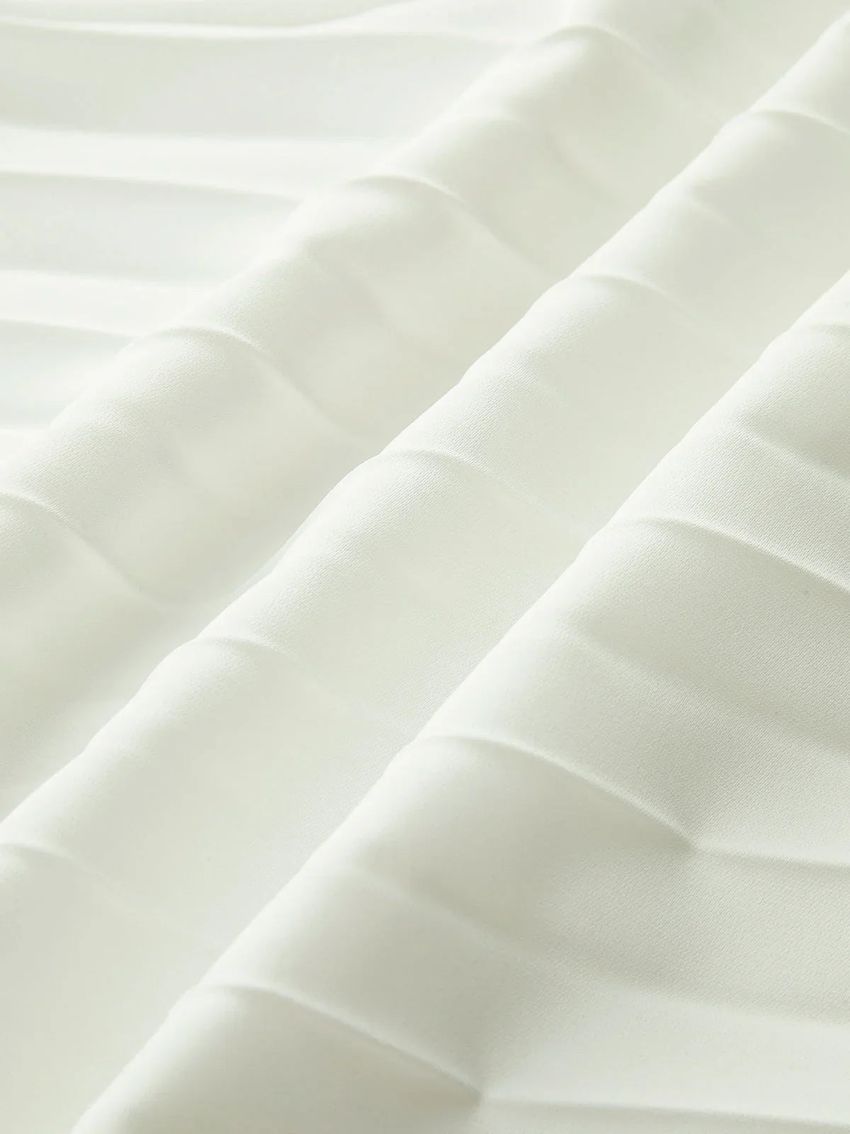 architectural," "sculptural," "asymmetrical," "bonded crepe," and "sunray pleats