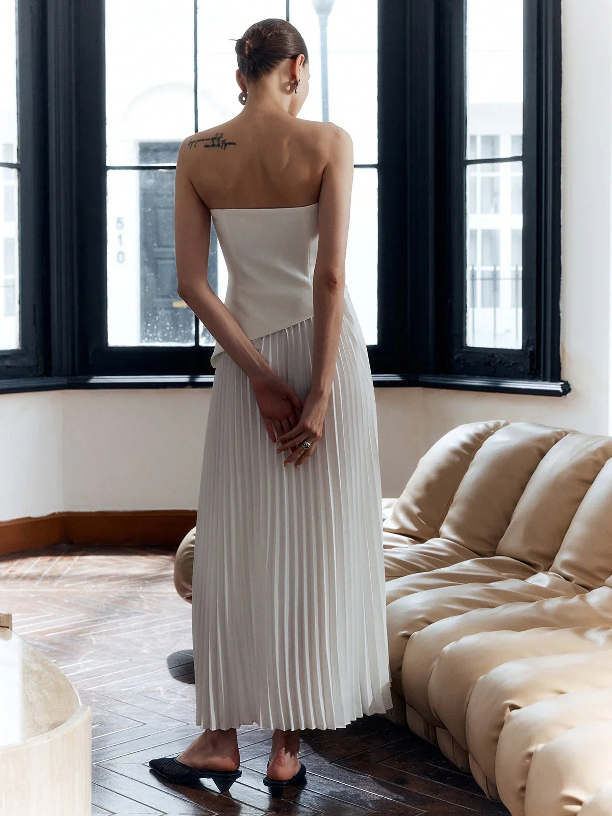 architectural," "sculptural," "asymmetrical," "bonded crepe," and "sunray pleats