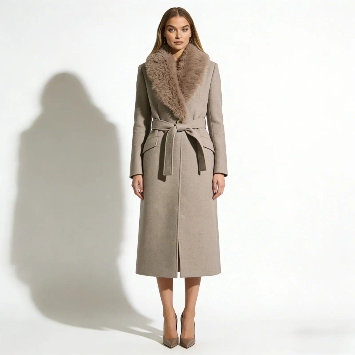 A woman wearing the Kouvr Fashion Trisha long oatmeal khaki wool wrap coat with a plush shearling fur collar, tied at the waist.