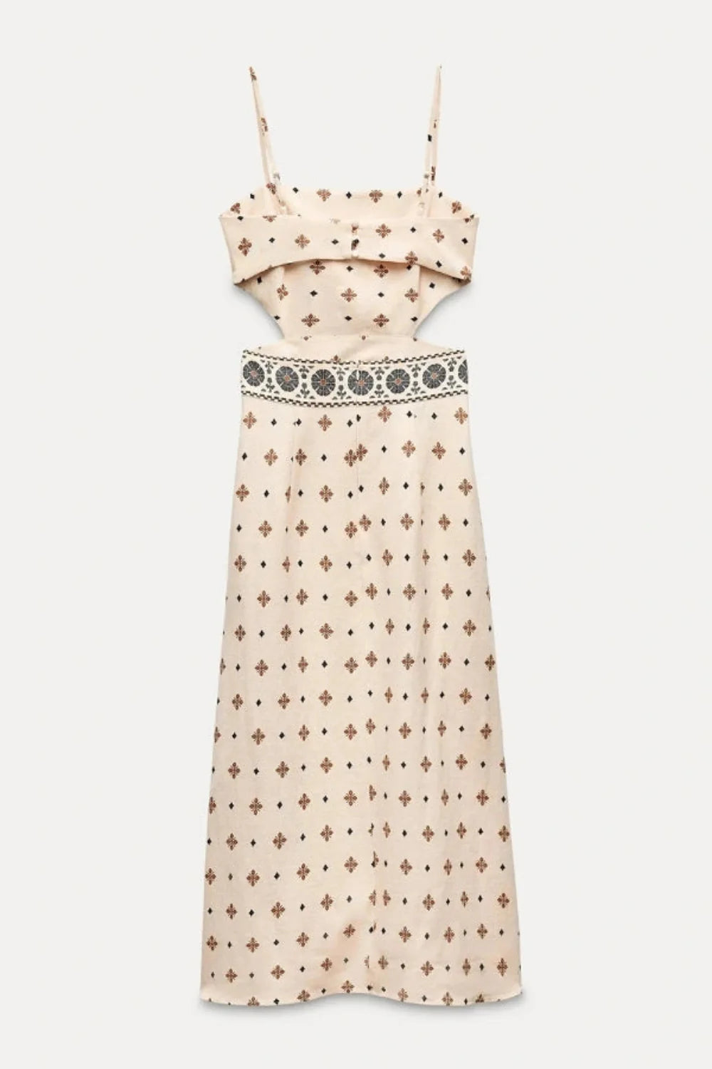 Model wearing Kouvr Vernice embroidered linen cutout midi dress sitting outdoors