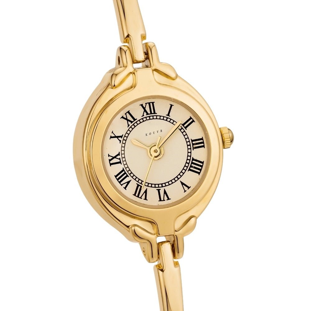 Gold Kouvr wristwatch with a beige face and black Roman numerals on a white background