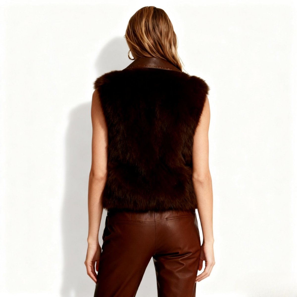 Person wearing a Dark brown Kouvr fur vest on a white background