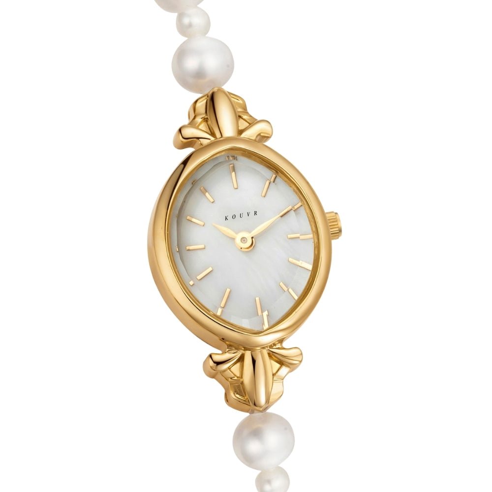 Gold Kouvr watch with pearl strap on a white background