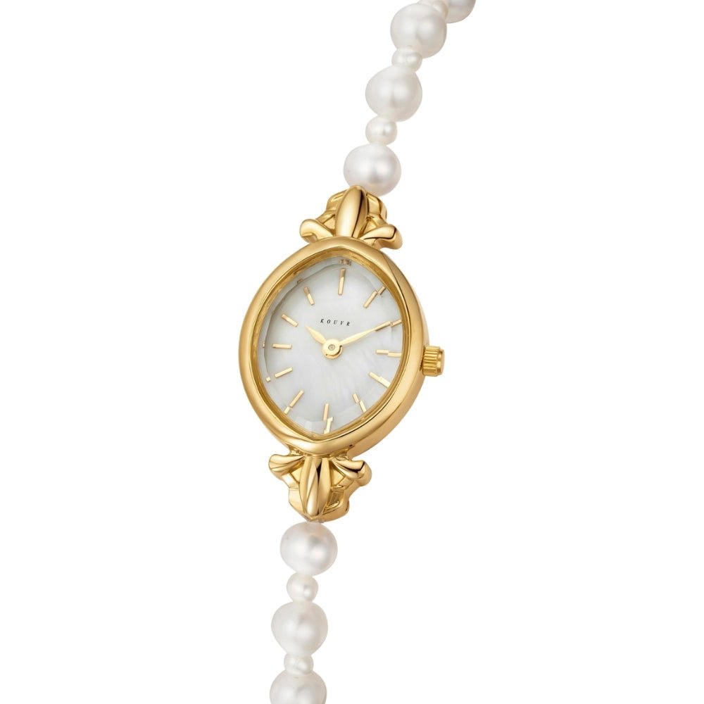 Gold Kouvr watch with a pearl strap on a white background