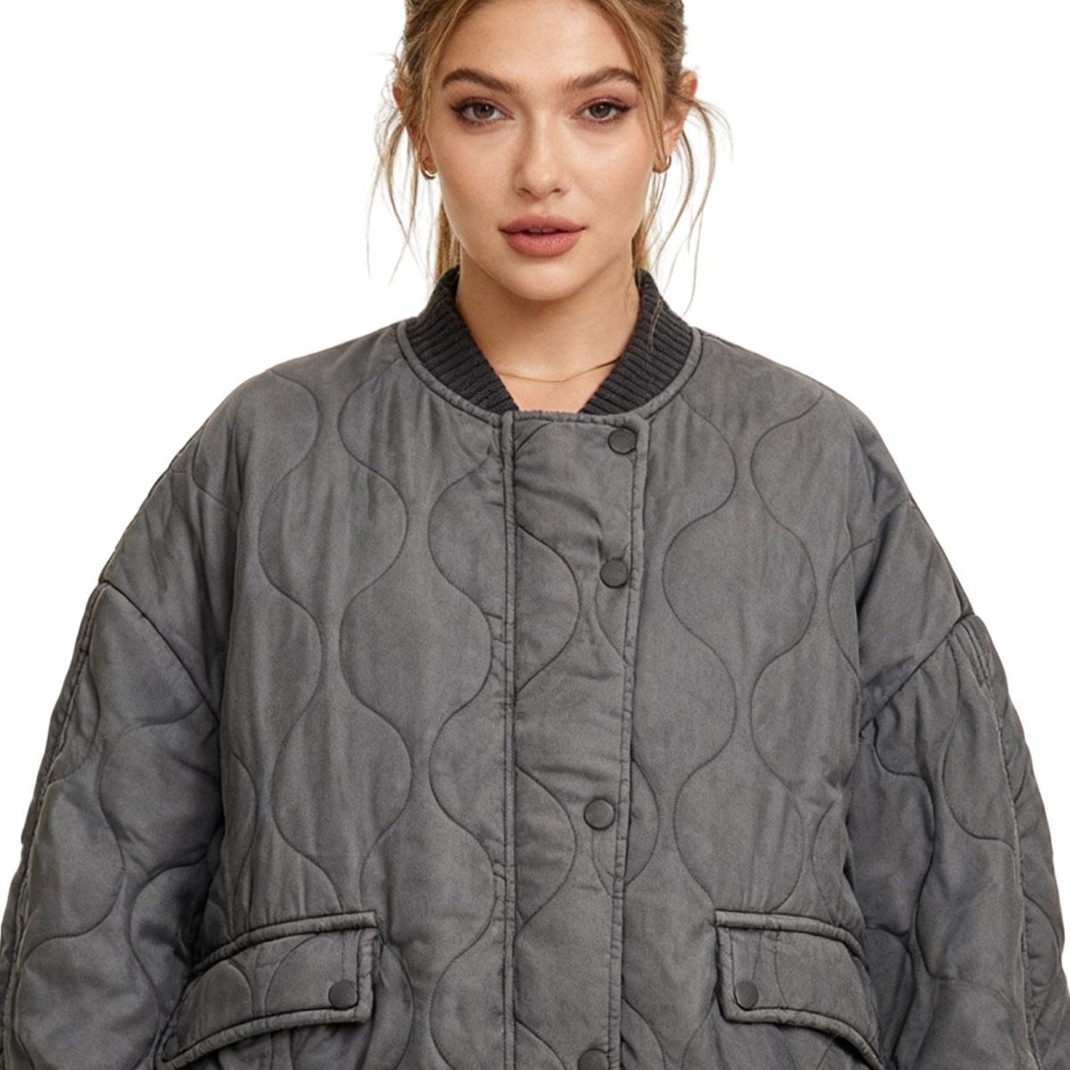 Woman wearing a gray kouvr quilted jacket on a white background