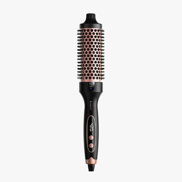Black and rose gold thermal brush by Kouvr with 1.5 inch heated barrel and adjustable heat settings for salon-quality blowouts at home.