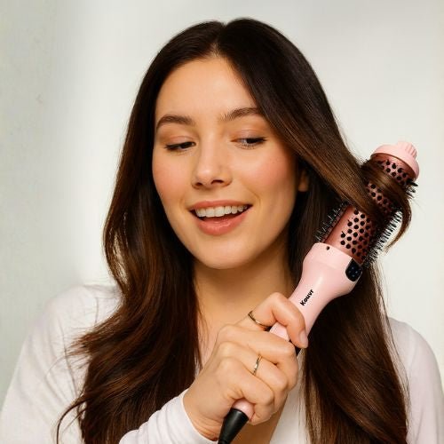 Pink Kouvr thermal brush with rose gold ceramic barrel and digital temperature display showing 420 degrees for creating frizz-free volume.