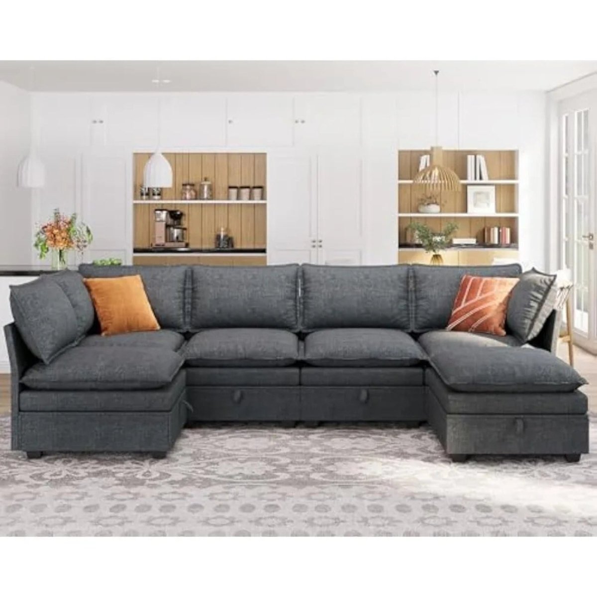 Kouvr Dark Grey sectional sofa with orange cushions in a living room setting.
